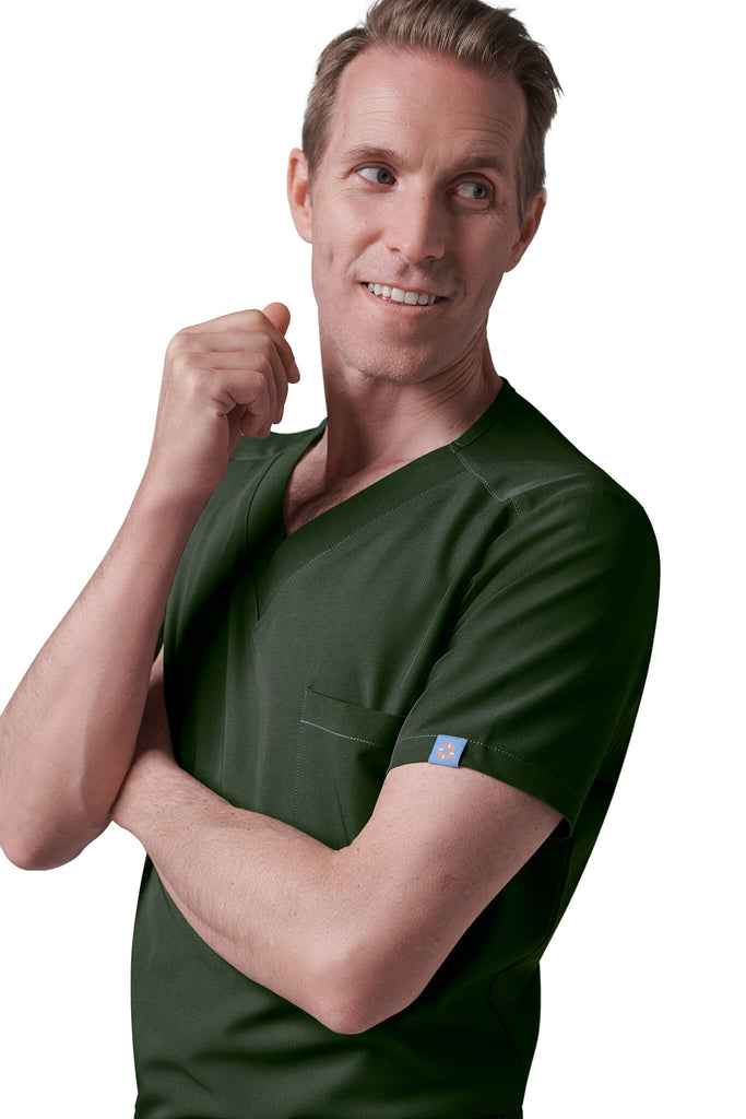 MedTailor Men's Scrubs Collection. Man wearing a MedTailor scrubs set in Highland Green fabric color.