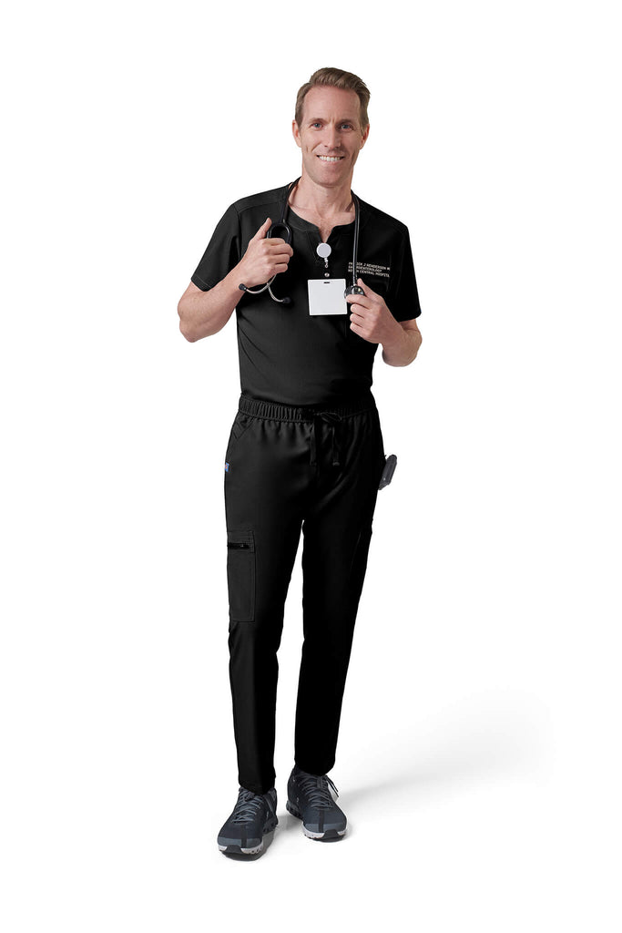 Man wearing MedTailor men's scrub top in Jet Black color fabric