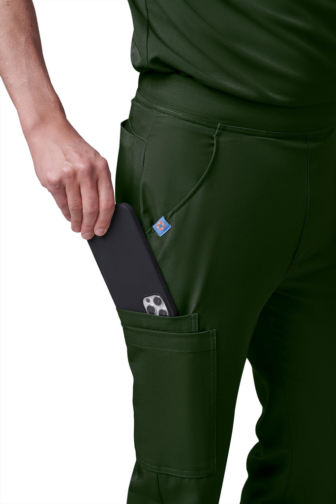 Man wearing MedTailor men's scrub pants in Highland Green color fabric