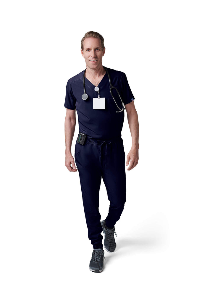 Man wearing MedTailor men's scrub pants in Navy Blue color fabric