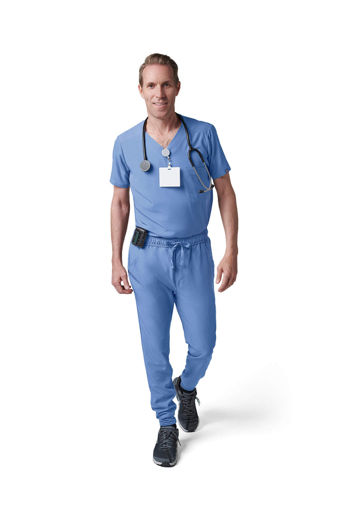 Man wearing MedTailor men's scrub pants in Sky Blue color fabric