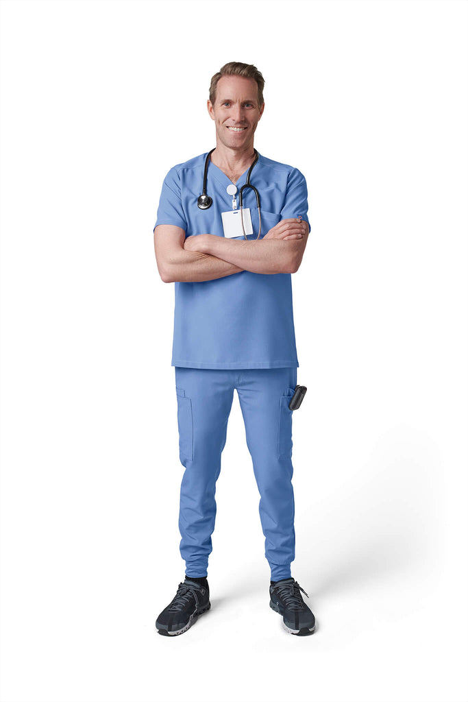 Man wearing MedTailor men's scrub pants in Sky Blue color fabric