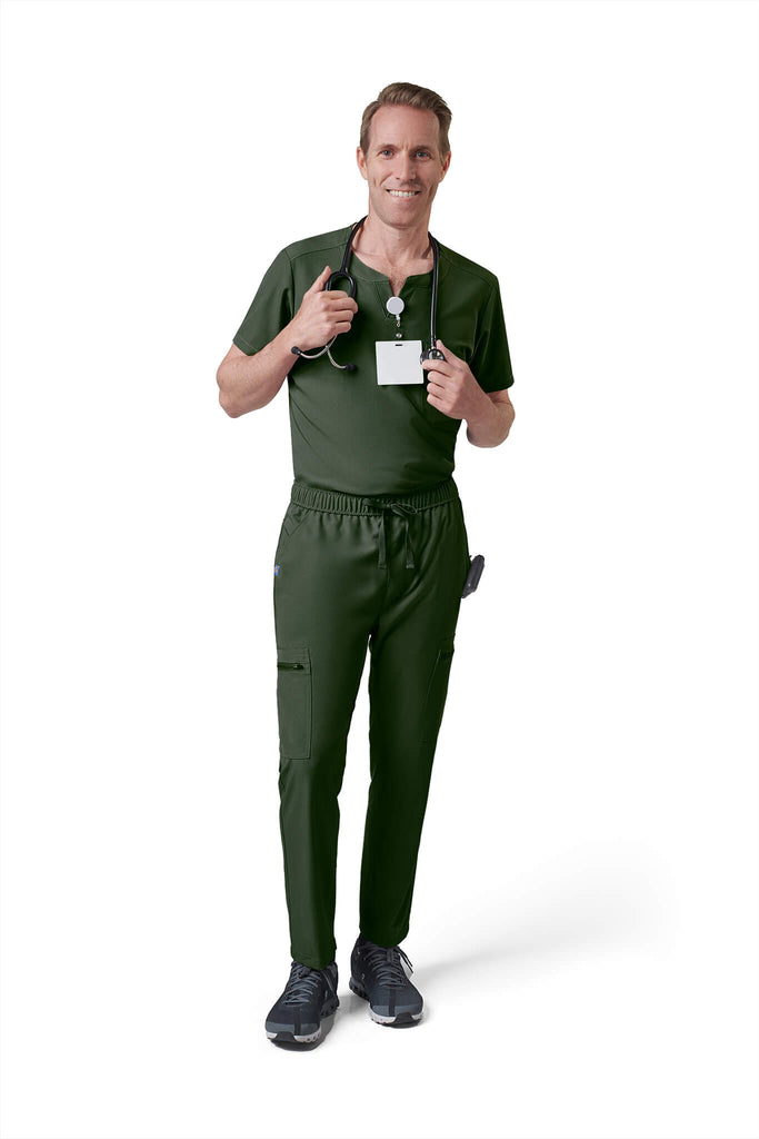 Man wearing MedTailor men's scrub top in Highland Green color fabric