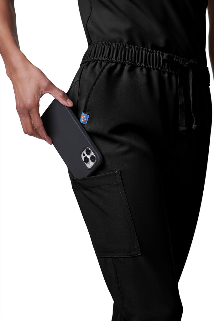 Woman wearing MedTailor women's scrub pants in Jet Black color fabric