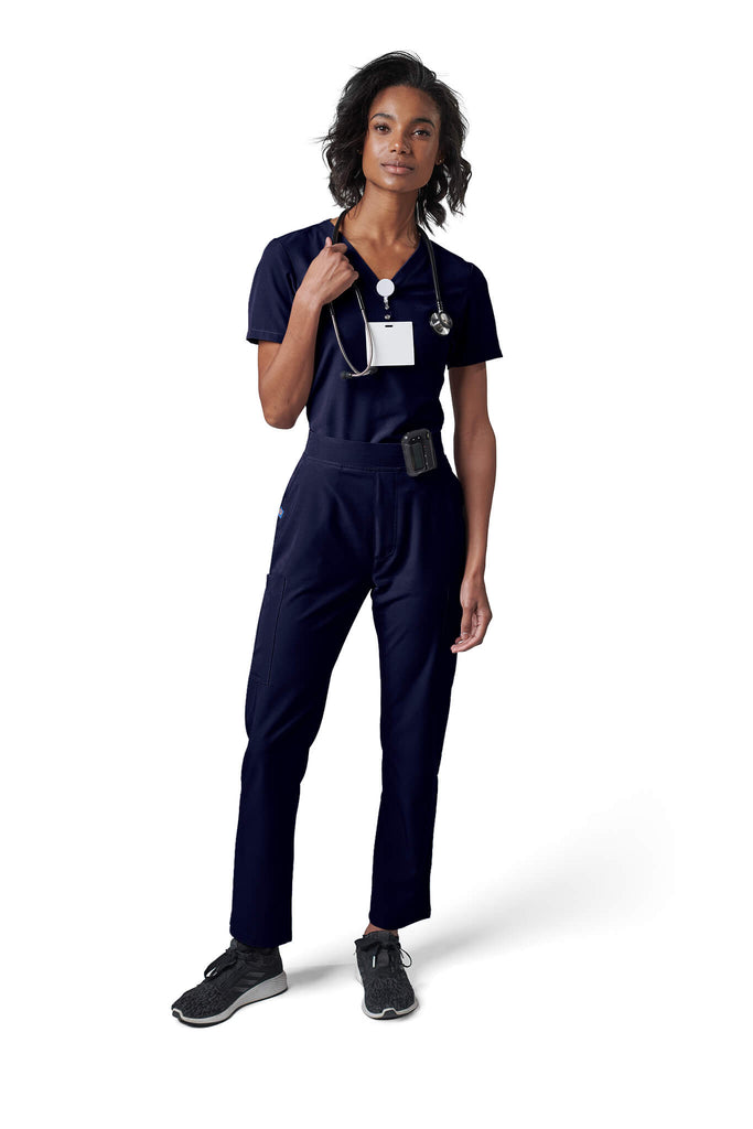 Woman wearing MedTailor women's scrub pants in Navy Blue color fabric