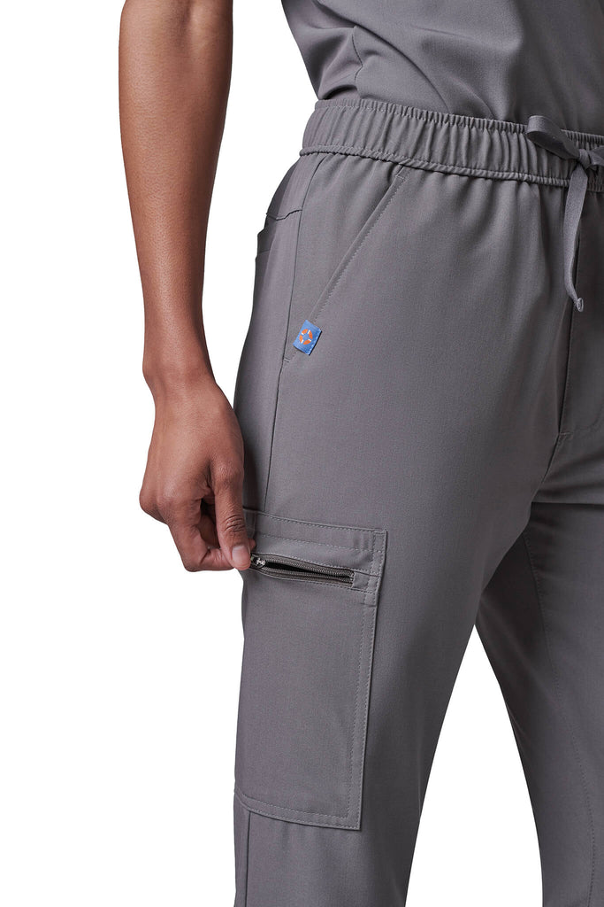 Woman wearing MedTailor women's scrub pants in Platinum Gray color fabric