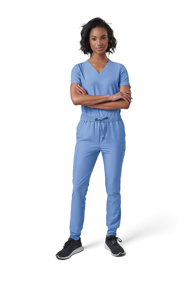 Woman wearing MedTailor women's scrub pants in Sky Blue color fabric