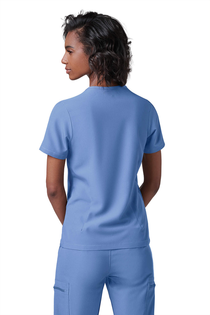 Woman wearing MedTailor women's scrub top in Sky Blue color fabric
